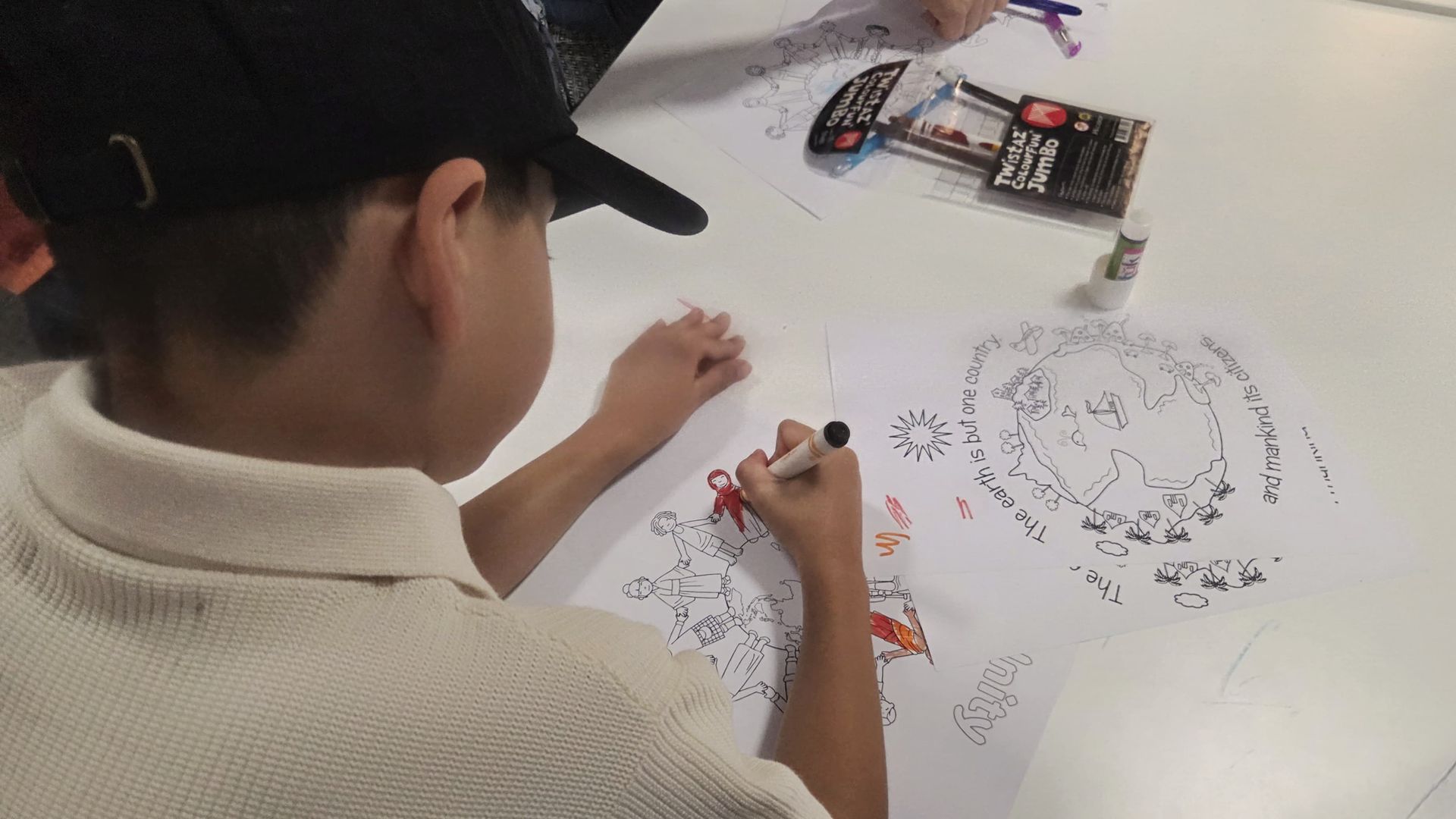 A child making artwork about the earth, countries and humanity