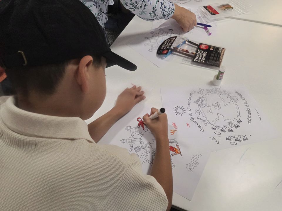 A child making artwork about the earth, countries and humanity