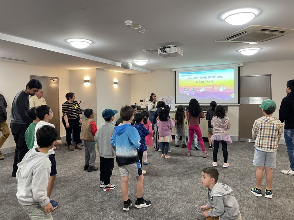Children taking part in a joyful group song and movement session
