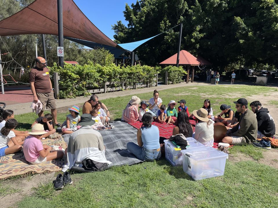 Families and children gathered in a circle at a Ryde park