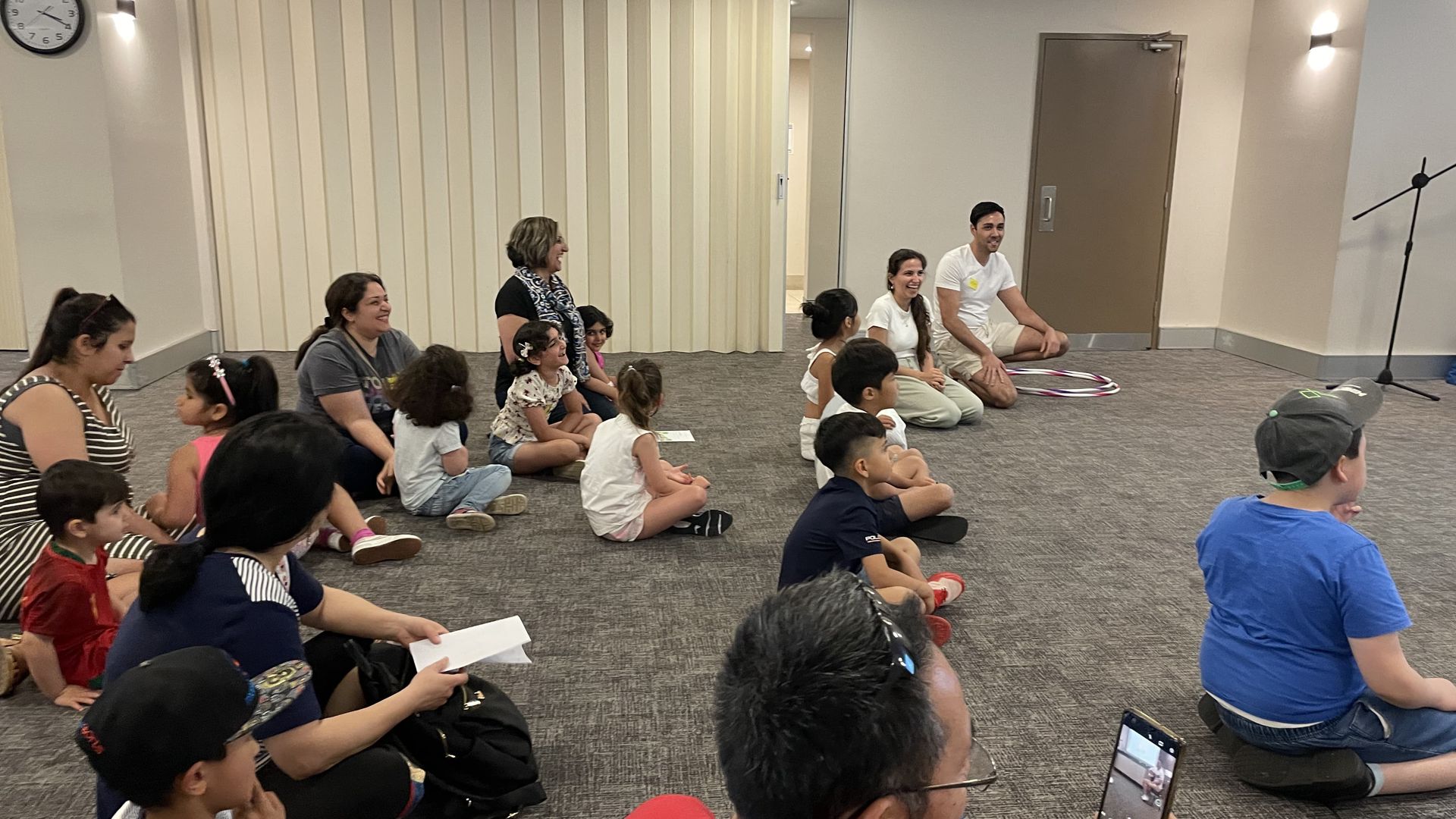 Families and children seated together during a community programme