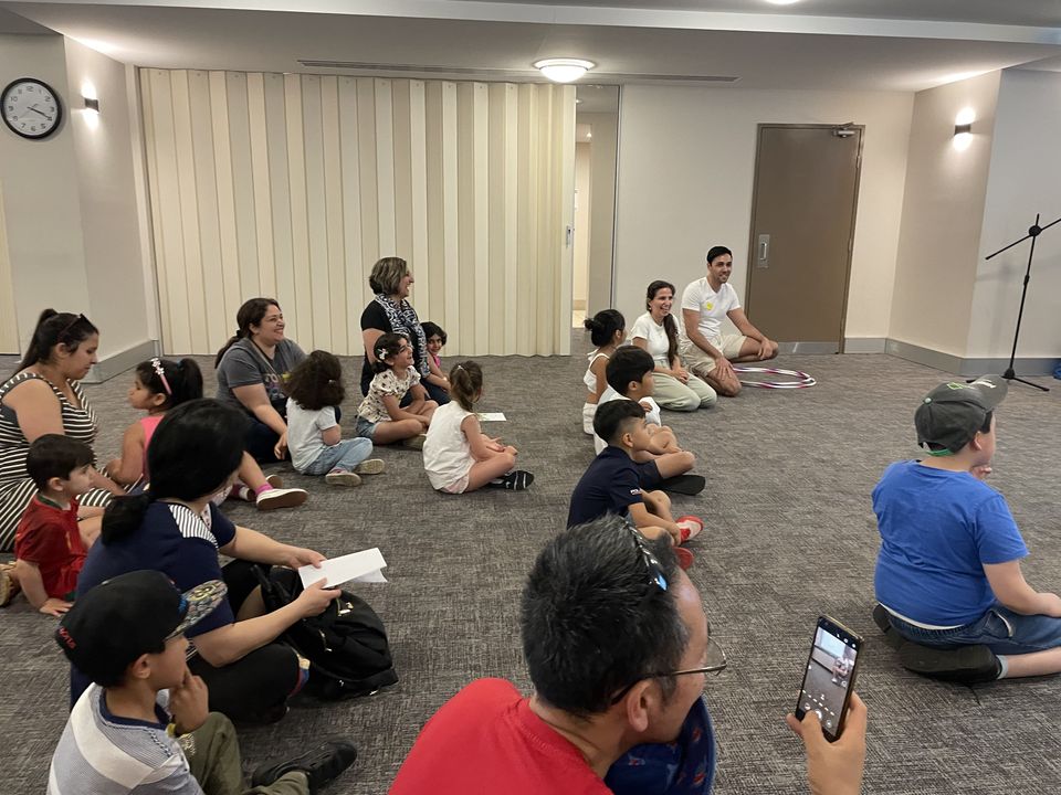 Families and children seated together during a community programme