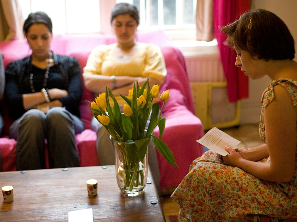 Friends sharing prayers and sacred readings at a devotional gathering